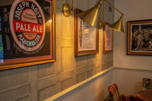 a bar with a pub sign on the wall at Woodthorpe Hotel in Manchester