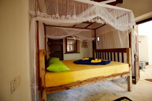 a bedroom with a wooden bunk bed with a canopy at Wine Tree Garden Guesthouse in Mirissa