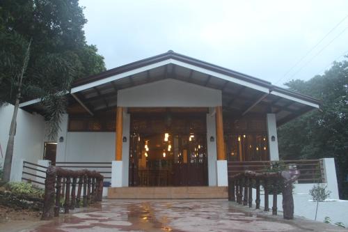 a building with a large door with lights in it at Coron Hilltop View Resort in Coron