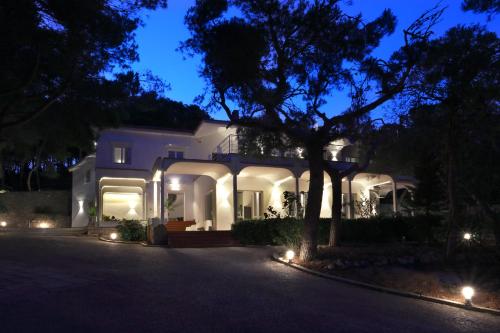 a white house at night with lights on it at Dimora Villa Serena Porto Selvaggio Gallipoli in Gallipoli