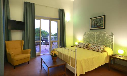 a bedroom with a bed and a chair at Dimora Villa Serena Porto Selvaggio in Santa Caterina di Nardò