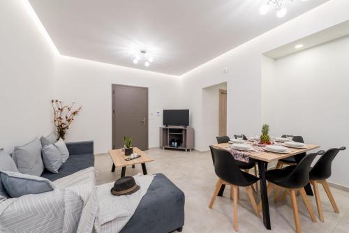 a living room with a couch and a table at Jasmine Suites with Private Pool in Tsilivi