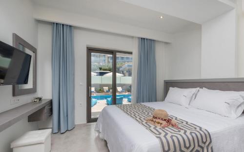 a bedroom with a bed with a teddy bear on it at Jasmine Suites with Private Pool in Tsilivi