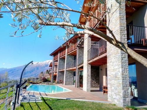 a house with a swimming pool and a deck at Il Giardino Di Lory in Vercana