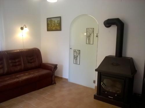 a living room with a stove and a couch at ZENITH APARTMAN in Gárdony