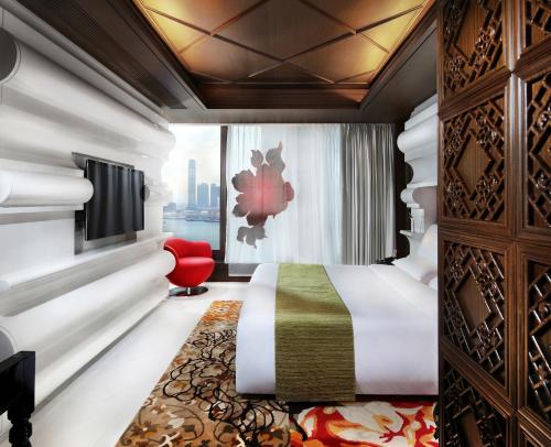 a hotel room with a bed and a window at Mira Moon in Hong Kong