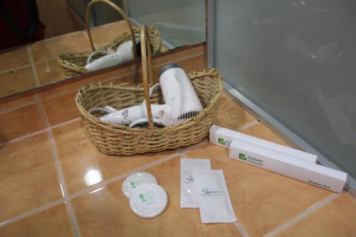 a basket of toothbrushes sitting on a tile floor at Elegant Circle Inn in Cebu City