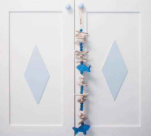 a wall with shells and kites on a white wall at Roula Villa Studios & Apartments in Perissa