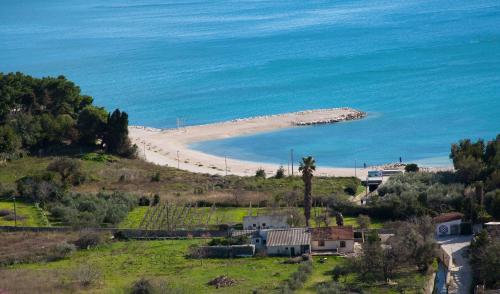 a view of a beach with a house and the ocean at Apartment Amalfi in Split