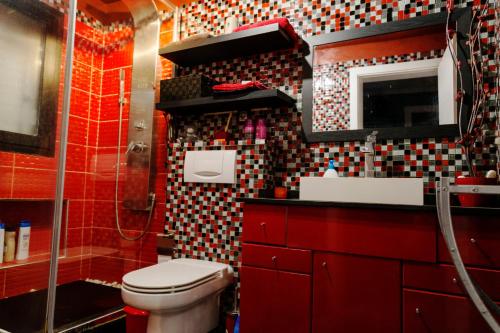 a bathroom with a toilet and a sink and a mirror at MA PETITE ILLUSION,SUNSET,OCEAN VIEw in Santa Úrsula