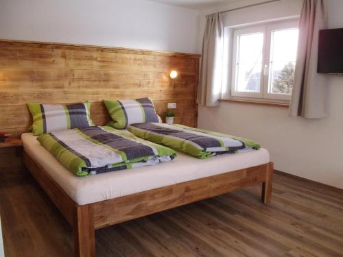 a bedroom with two beds and a window at Rosenhof in Isny im Allgäu