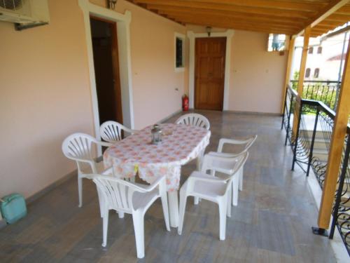 a table and chairs on the balcony of a house at Villa Xenos in Kalamaki