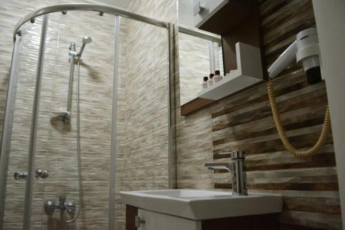a bathroom with a sink and a shower at Bormali Hotel in Çorlu