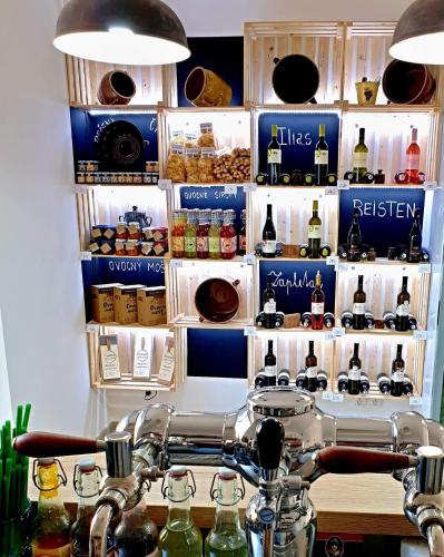 a room with a shelf of bottles of alcohol at Penzion jako víno in Bulhary