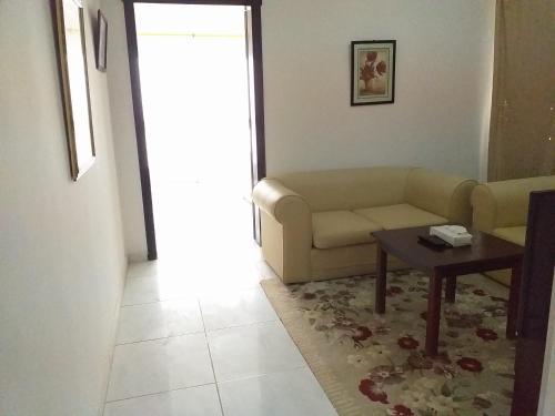 a living room with a couch and a table at Salalah Beach Villas in Salalah