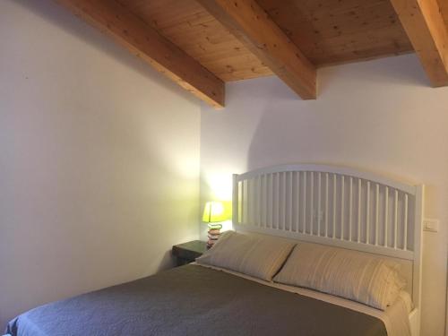 a bedroom with a bed and a wooden ceiling at Al Libro Letto in Viterbo