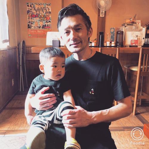 a man holding a young boy sitting on his lap at Guest house daisho oshiro asobi in Matsue