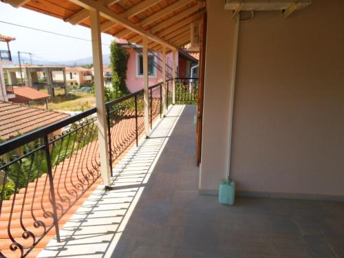 a balcony of a house with a railing at Villa Xenos in Kalamaki