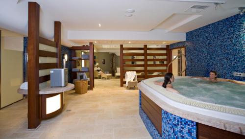 two people in a hot tub in a hotel room at Villa Cécile in Yvoire