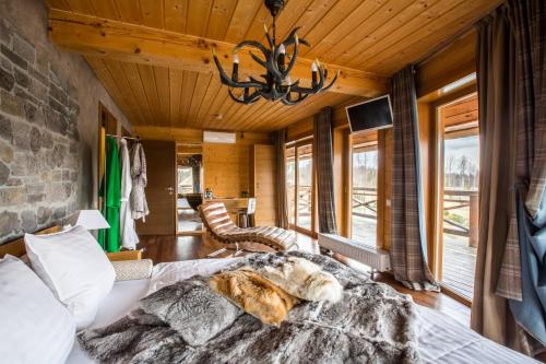 a bedroom with a bed and a stone wall at Jonathan Spa Estate in Amatciems