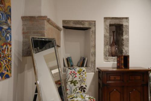 a room with a mirror and a dresser and a shelf at Al Libro Letto in Viterbo