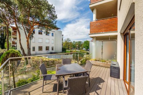 a patio with a table and chairs on a balcony at Wczasowa, Sun & Snow in Ustka