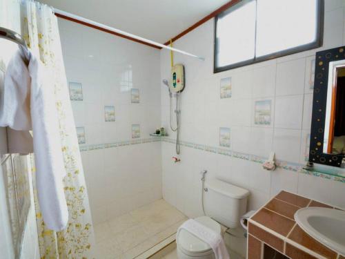 a bathroom with a shower and a toilet and a sink at Avila Resort Pattaya in Jomtien Beach