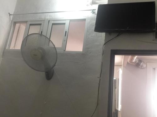 a fan hanging on a wall next to a building at Pensión Teruel in Barcelona