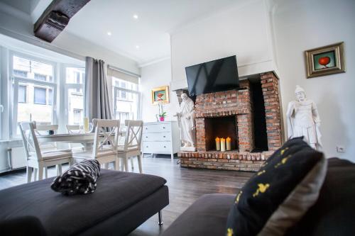 a living room with a couch and a fireplace at Luxury Suites Cathedral in Antwerp
