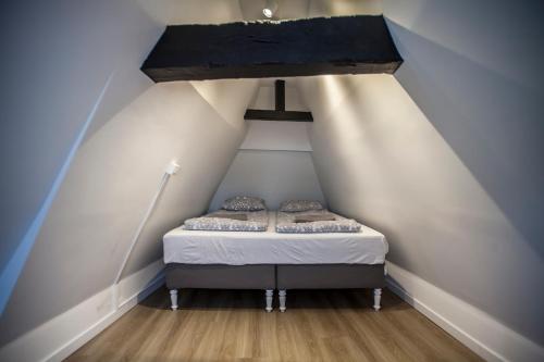 a small bed in the middle of a attic at Luxury Suites Cathedral by Rikas Hotels in Antwerp