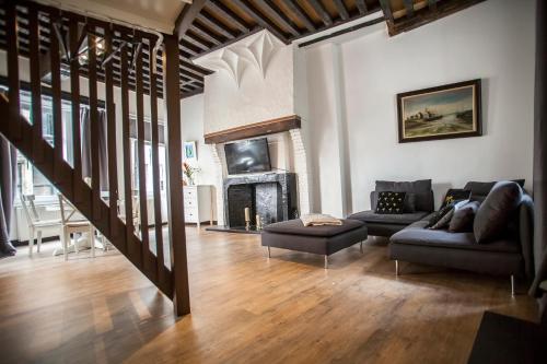 a living room with a couch and a fireplace at Luxury Suites Cathedral by Rikas Hotels in Antwerp