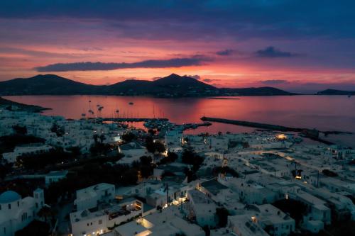a view of a city at night with a sunset at Bohemian Luxury Boutique Hotel, Adults Only in Naousa