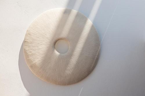 a cymbal sitting on top of a wall at Bohemian Luxury Boutique Hotel, Adults Only in Naousa
