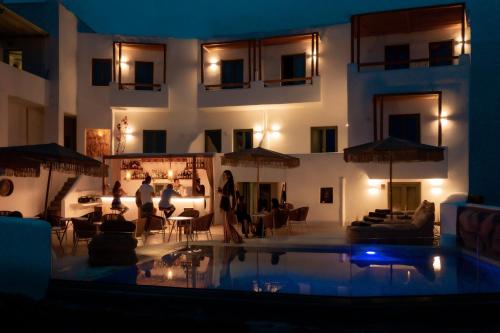 a building with a swimming pool at night at Bohemian Luxury Boutique Hotel, Adults Only in Naousa