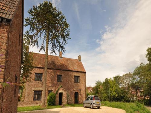 a car parked in front of a building with a tree at Langley Inn in Bristol
