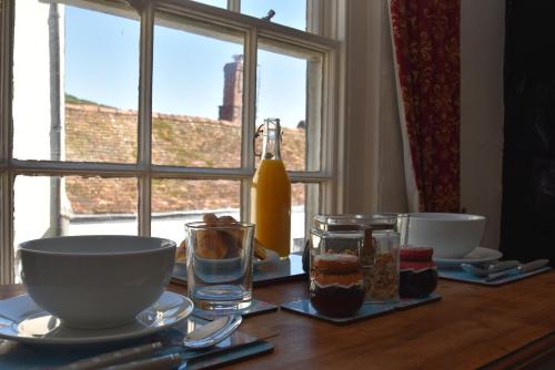 a table with food on it with a window at Old Town Bolthole in Hastings