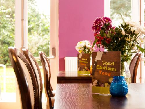 a table with flowers and a bag of food on it at YHA Stratford-Upon-Avon in Stratford-upon-Avon