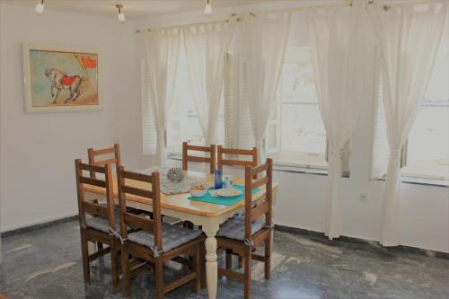 a dining room with a table and four chairs at Hydra's View in Hydra