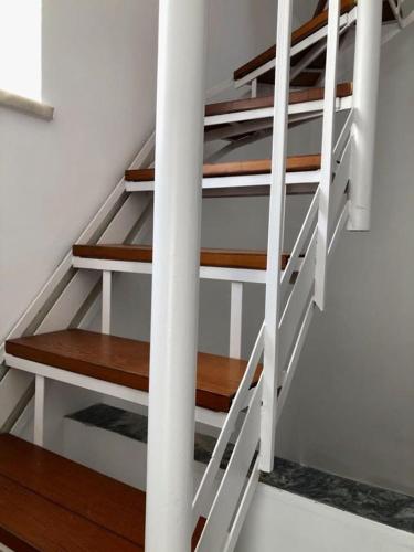 a set of stairs in a room with wooden floors at Hydra's View in Hydra