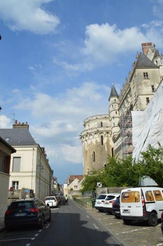 une rue avec des voitures garées devant un château dans l'établissement Cosy studio, at foot of - au pied du, Château d'Amboise, à Amboise