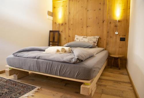 a dog laying on a bed in a room at B&B Cedavécia in Comèlico Superiore