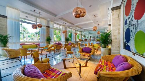 a lobby with chairs and tables in a restaurant at BULL Costa Canaria & SPA - Only Adults in San Agustin