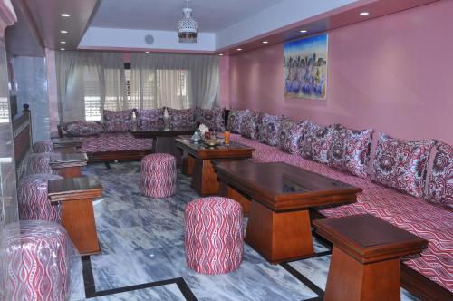 a living room with a couch and tables and chairs at HOTEL DELTA ATLAS in Casablanca