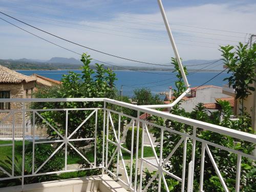 a balcony with a view of the water at Erato Apartments in Petalidhion