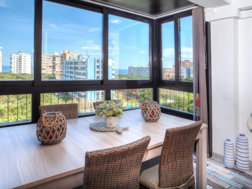 comedor con mesa, sillas y ventanas en Apartment Incar by Interhome, en Blanes