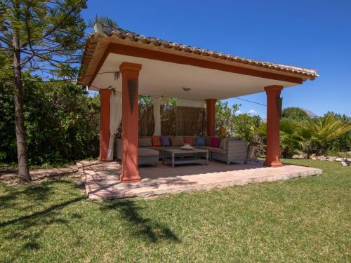 a pergola with a couch and a table in a yard at Villa Villa Adelfa by Interhome in Jávea