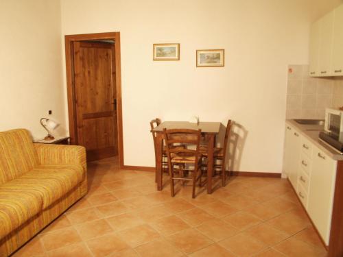 a living room with a table and chairs and a couch at Agriturismo Casella Del Piano in Gubbio