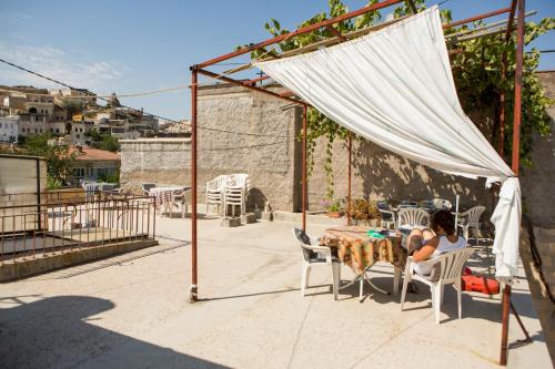 a couple sitting at a table under a canopy at Atak Hotel in Goreme