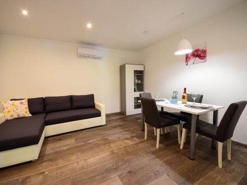 a living room with a couch and a table at Apartment Sandra by Interhome in Matulji
