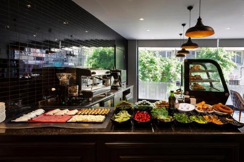 a buffet of food on a counter in a kitchen at Güner Business Hotel in Istanbul